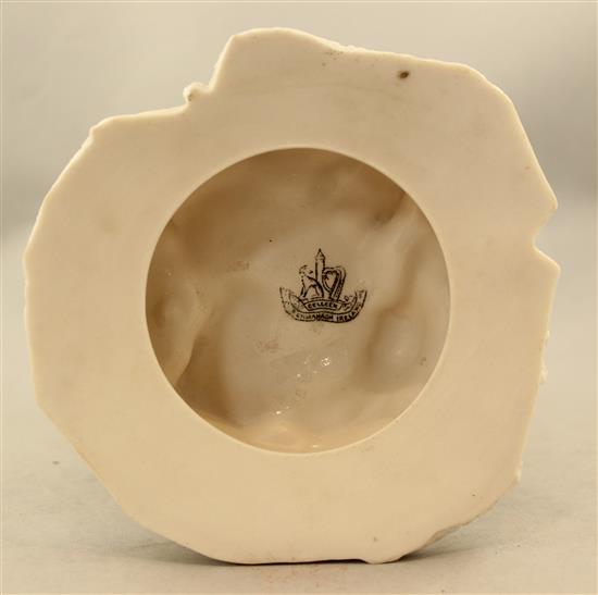 A Belleek bird and nest on a stump vase, late 19th century, 32cm, loss to bird